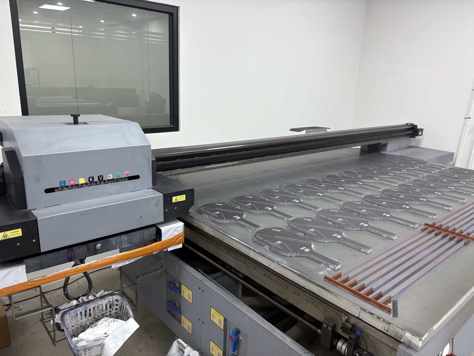 UV printing machine printing custom pickleball paddle surfaces at Volleon